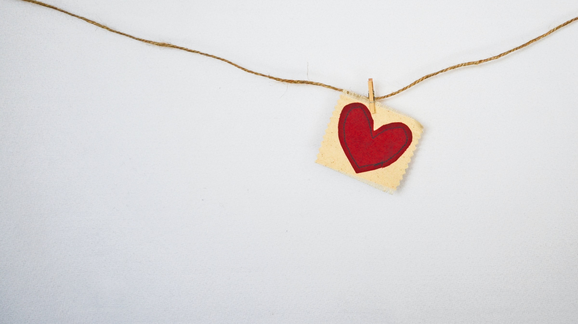 Do You Need a Life Coach? Heart pinned to string on the wall